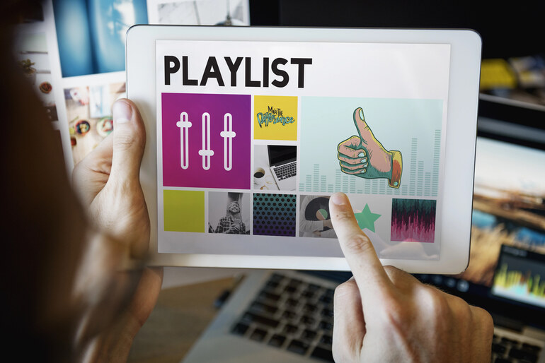 Musician using a tablet to place one of his playlists
