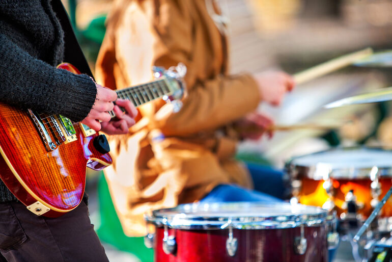 Guitarist and drummer performing live at a top US music festival