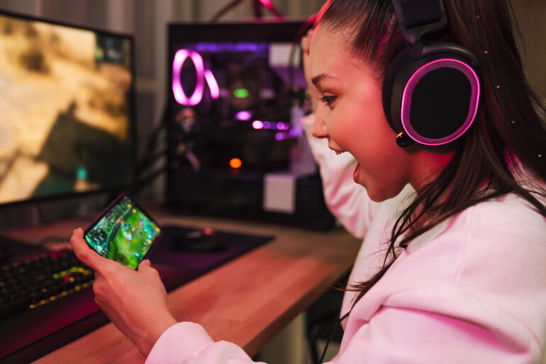 A young girl is playing a mobile game in Canada