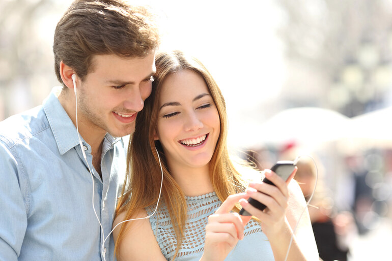 A happy couple listening to music