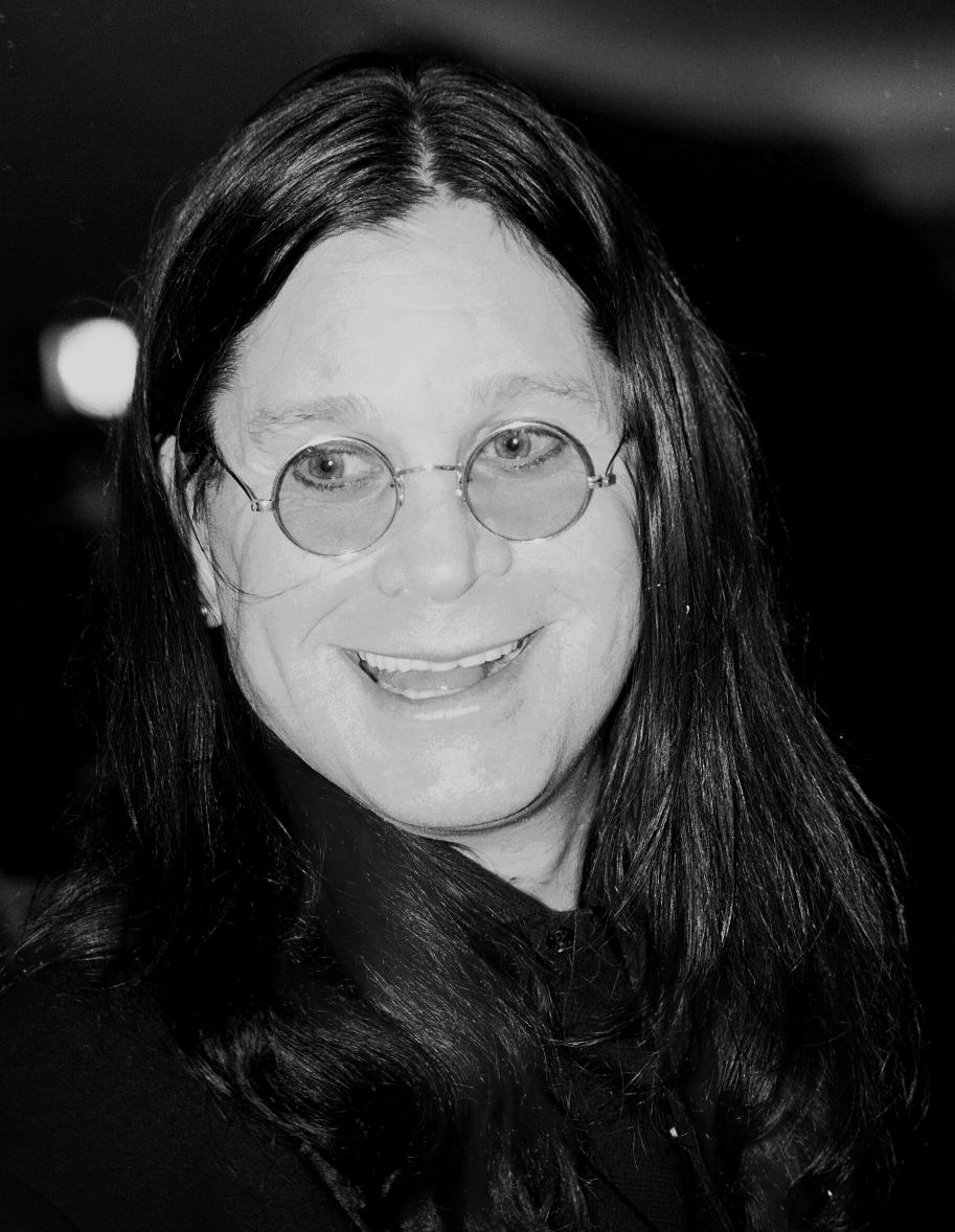 Ozzy Osbourne smiling with circular glasses on