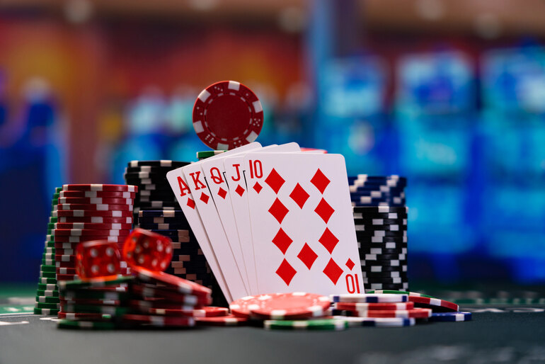 Royal Flush in Diamonds with Poker Chips and Dice on a Casino Table