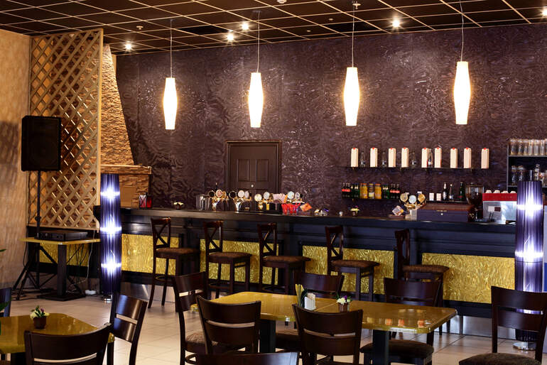 Acoustic-optimized restaurant bar stools arranged in a stylish venue with sound-absorbing design elements