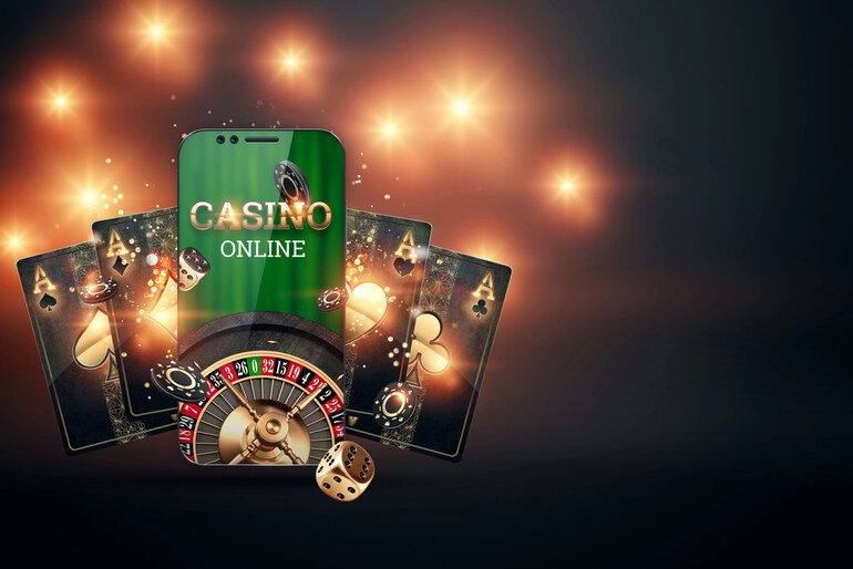 Online casino concept with smartphone, roulette wheel, playing cards, and dice