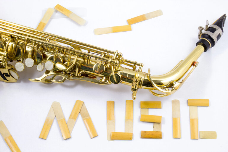 A close-up of a golden saxophone with the word “MUSIC” spelled out in reeds, symbolizing smooth jazz, bossa nova, and instrumental funk themes.