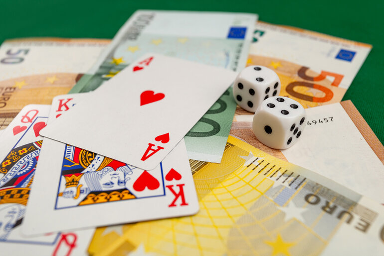 Playing cards, dice, and euro banknotes symbolizing winnings at fast payout online casinos in Poland