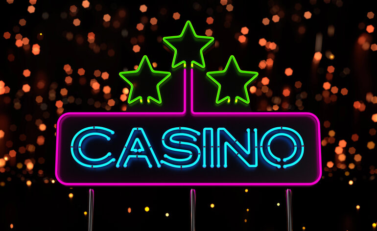 Bright neon casino sign glowing with stars and colorful lights.