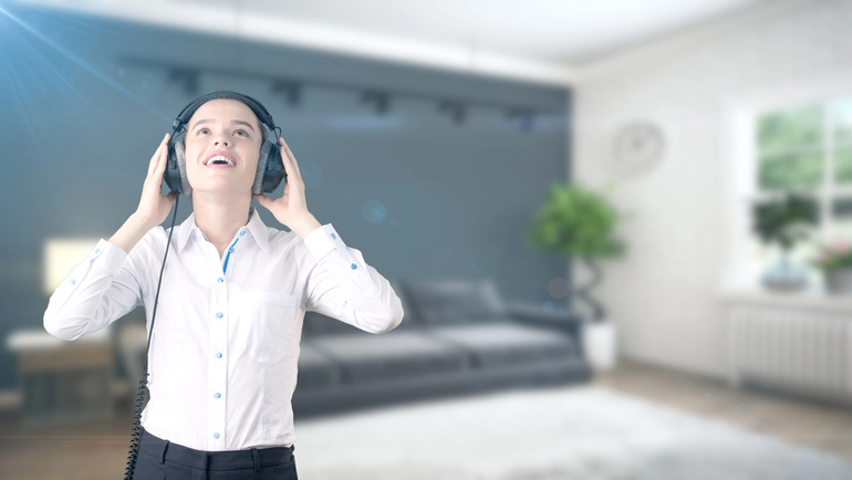Young person enjoying high-quality audio with headphones in a modern living room