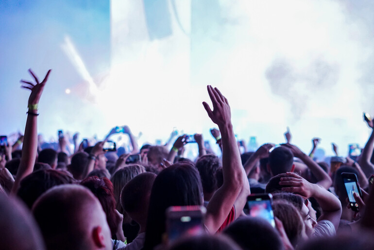 Excited fans enjoying a live music concert in 2025