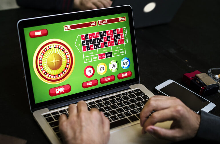 Player enjoying an online roulette game on a laptop, showcasing the thrill of modern jackpot gaming in the digital era.