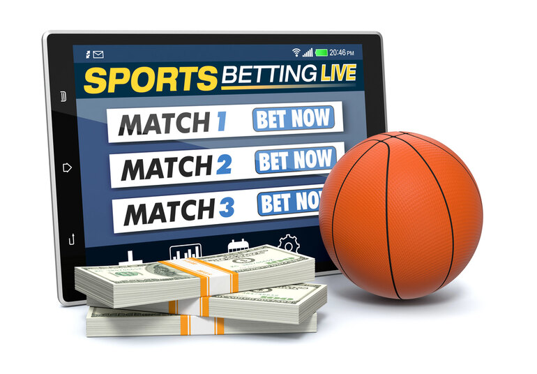 Live basketball betting concept with a tablet showing match options, money stacks, and a basketball.