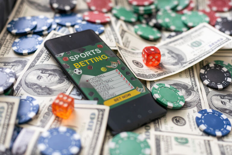 A smartphone showing a live sports betting screen on the 4Rabet app, surrounded by cash, poker chips, and dice, illustrating a step-by-step betting guide designed for music-loving users.