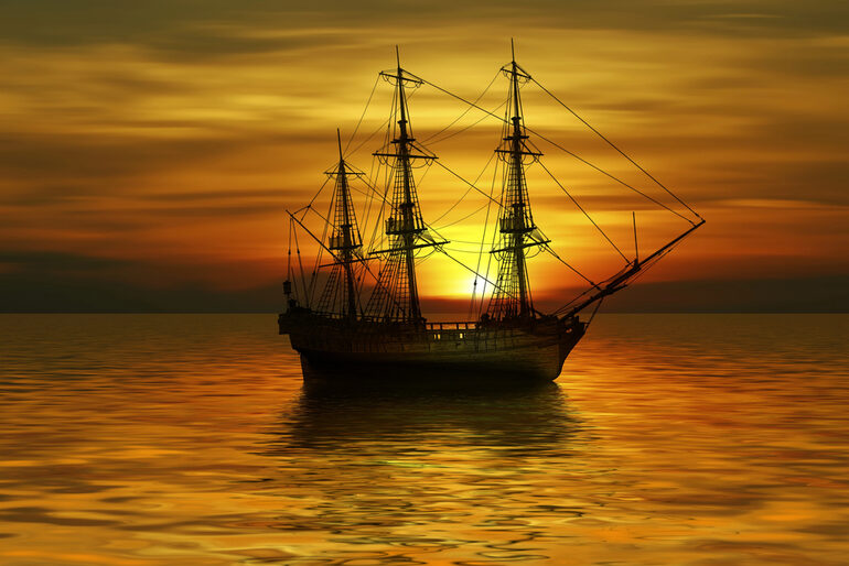 Old sailing ship on calm ocean at sunset for a high-seas playlist theme.