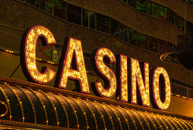 Glowing “CASINO” marquee sign at night, highlighting casino atmosphere