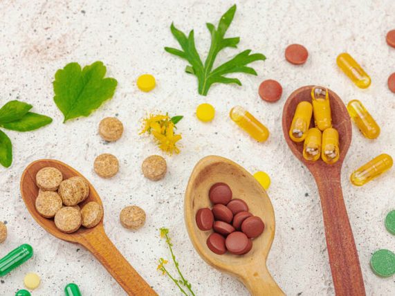 Plant-based supplements, natural vitamins with fresh herbs and flowers