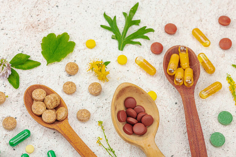 Plant-based supplements, natural vitamins with fresh herbs and flowers