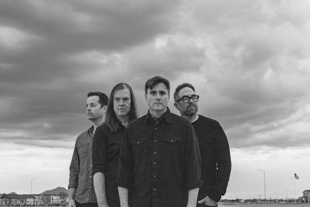 Jimmy Eat World beneath cloudy sky, announcing 25th anniversary of Bleed American.