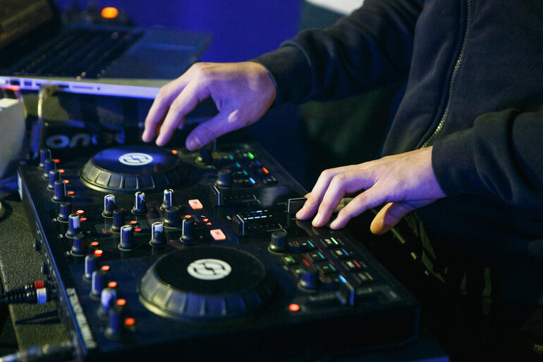 DJ preparing mix on controller for live performance