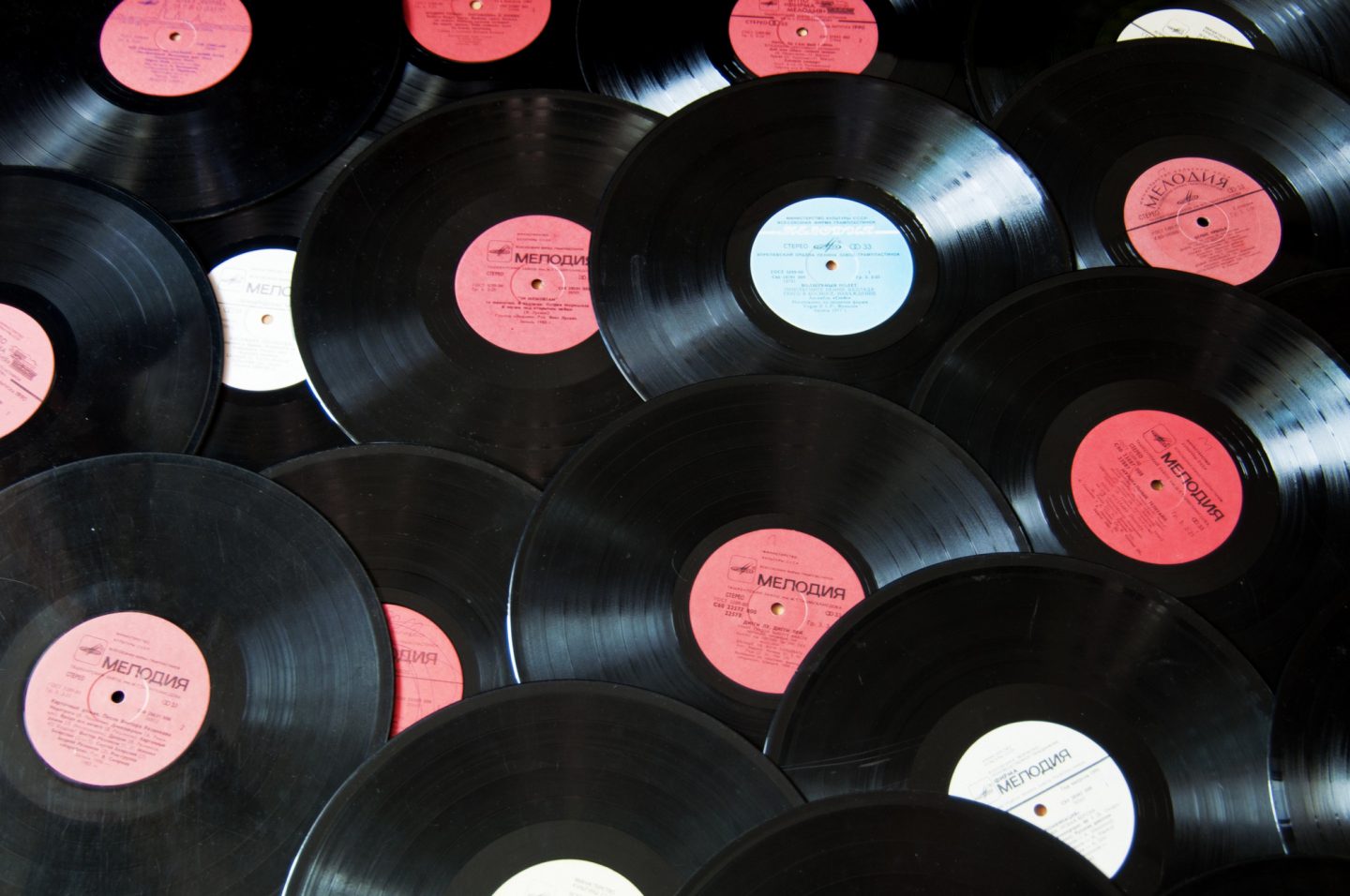 Colorful vintage vinyl records celebrating album anniversaries in 2026, arranged in bins, photographed from above.
