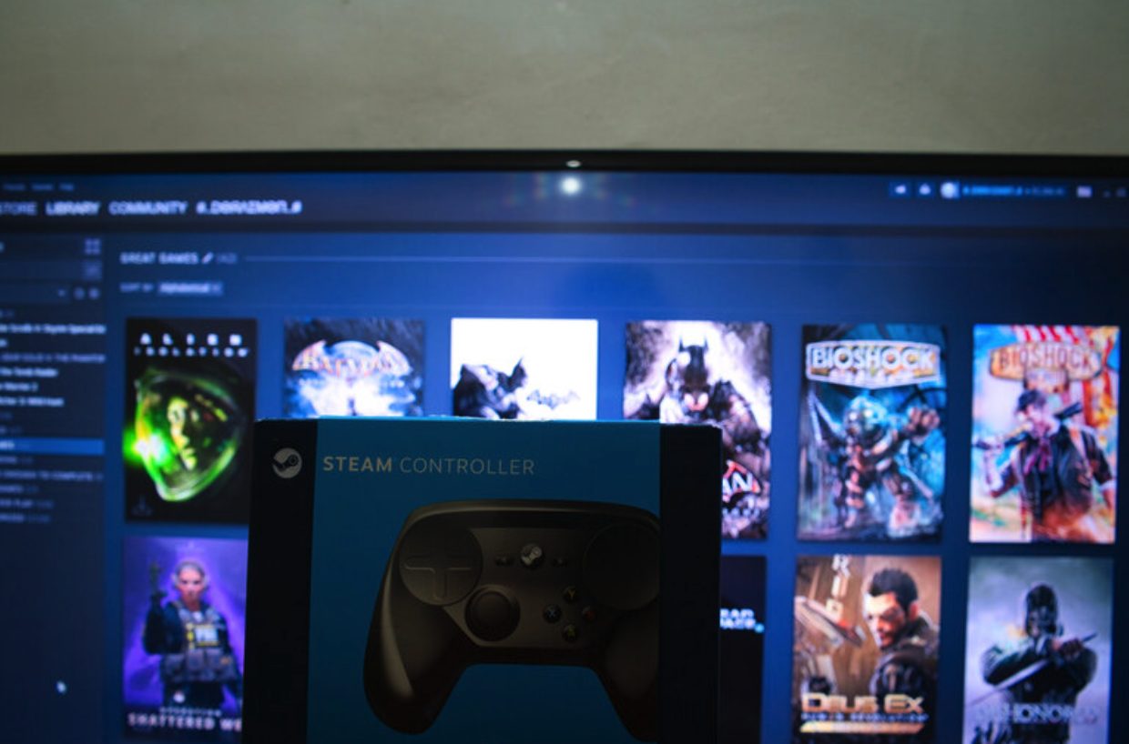 : Gaming background with game controller and computer screen highlighting a collection of computer games with a focus on the popular video games of 2016 as a reminder of how much music fans love them.