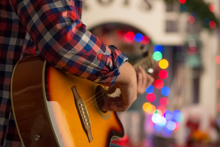 Live Guitar Performance Inside Casino Entertainment Venue with Colourful Lights and Vibrant Music Atmosphere.