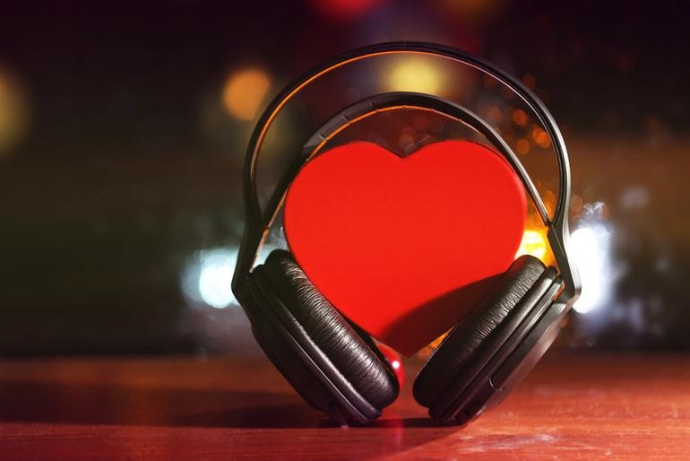 Headphones placed on a table, symbolizing how musical taste can offer insight into dating compatibility.