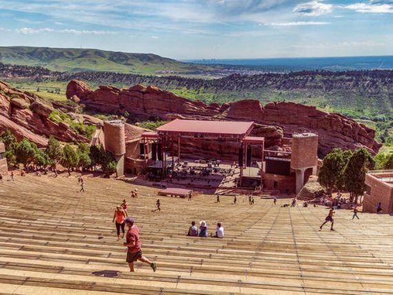 Red Rocks Amphitheatre concert venue with its iconic sandstone formations, outdoor stage, and scenic mountain backdrop.