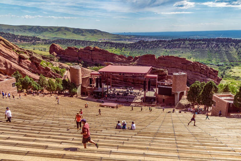 Red Rocks Amphitheatre concert venue with its iconic sandstone formations, outdoor stage, and scenic mountain backdrop.