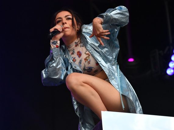 Charli XCX performing on stage.